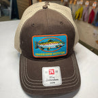 A brown and beige trucker hat with a colorful fish patch reading 'Chagrin River Outfitters' and a visible Richardson CSPM sticker on the brim, photographed on a tabletop in a store.
