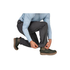 Person wearing gray Simms MEN's Waypoints Pant and brown boots on a white background