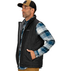 Man wearing a black Simms MEN's Fall Run Insulated Vest w/CRO Logo over a plaid shirt with a cap on a white background