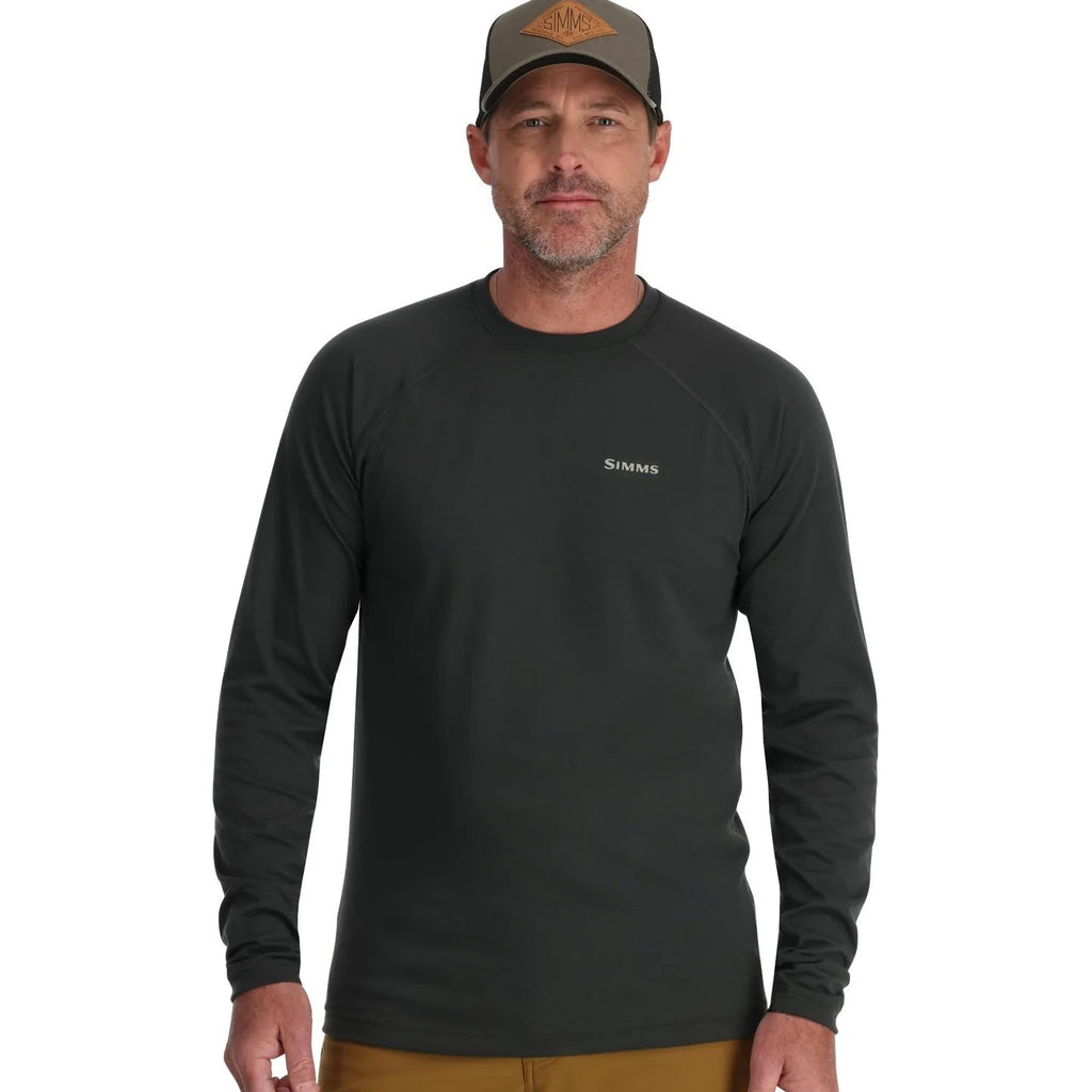 Man wearing a black long-sleeve shirt with a logo on a white background