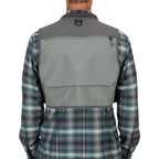 Person wearing a plaid shirt under a gray Simms Freestone Vest on a white background