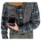 Person wearing a plaid shirt with a gray and black Simms Freestone Vest