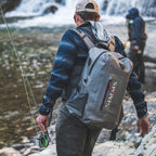 Gray Simms Dry Creek Z Backpack with orange 'Simms' logo on a white background