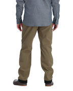 Person wearing brown Simms MEN's Rogue Softshell Pants and a gray shirt on a white background