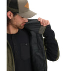 Man wearing a black jacket with green accents and a matching cap on a white background