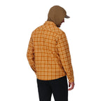 Person wearing a yellow plaid shirt and brown hooded jacket on a white background