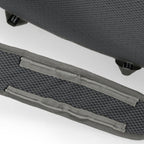 Close-up of a textured gray suitcase with a handle on a white background