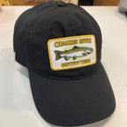 Black cap with Chagrin River Outfitters patch featuring a fish on a white surface.