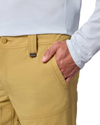 Close-up of mustard yellow Simms guide pants with a white shirt on a white background