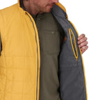 Person wearing a yellow and gray quilted Simms MEN's Fall Run Insulated Vest w/CRO Logo with a green shirt underneath.