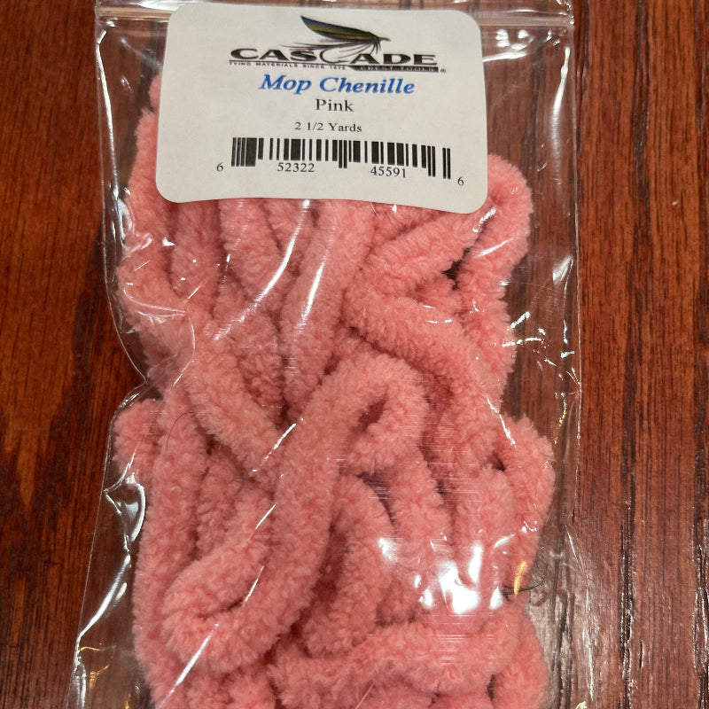 Pink chenille for fly tying in clear packaging on a wooden surface with a label.