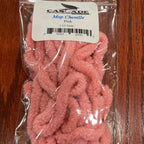 Pink chenille for fly tying in clear packaging on a wooden surface with a label.