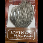 Packaged Ewing Hackle dry fly top cape on a wooden surface