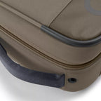 A green Orvis Carry-It-All fishing rod case with a shoulder strap and brand logo visible.