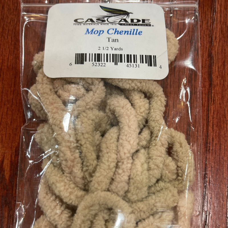 Packaged tan mop Chenille on a wooden surface with a label.