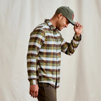 Man wearing a plaid Orvis MEN's Flat Creek Tech Flannel Shirt and cap against a plain background