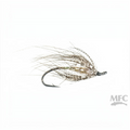 A single fly fishing lure with a dark hook, gold glitter body, and brown and beige hackle feathers, shown on a plain white background with an MFC logo in the bottom right corner.