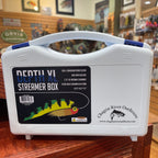 White tackle box labeled 'Death XL Streamer Box' by Chagrin River Outfitters on a wooden surface.