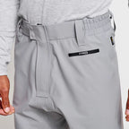 Close up of angler wearing a pair of Orvis men's PRO LT wading pants in gray color with neoprene booties and a belt, designed for waist-high wading.
