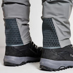 Close up of angler wearing a pair of Orvis men's PRO LT wading pants in gray color with neoprene booties and a belt, designed for waist-high wading.