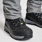 Close up of angler wearing a pair of Orvis men's PRO LT wading pants in gray color with boots and a belt, designed for waist-high wading.