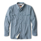 A long-sleeved blue fishing shirt with a button-up collar, button-adjustable cuffs, and a hidden bungee sunglasses/tool keeper in the right pocket. It features a concealed button-down collar that lays flat in the wind, button-adjustable cuffs, and a hidden sunglasses cleaner in the hem.