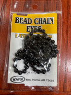 Packaged bead chain eyes for fly tying, available in black colors, displayed on a fly tying kit card.