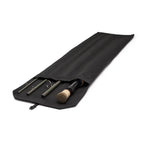 Black fishing rod and reel case with fishing equipment on a white background