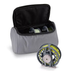 An image showing a Orvis Clearwater® Fly Reel & Spools 3-Pack fly fishing reel and two spare spools inside a gray padded soft case with zipper closure.
