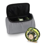 An image showing a Orvis Clearwater® Fly Reel & Spools 3-Pack fly fishing reel and two spare spools inside a gray padded soft case with zipper closure.