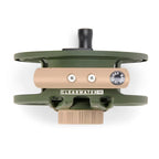 Top view of a green and beige fly fishing reel on a white background