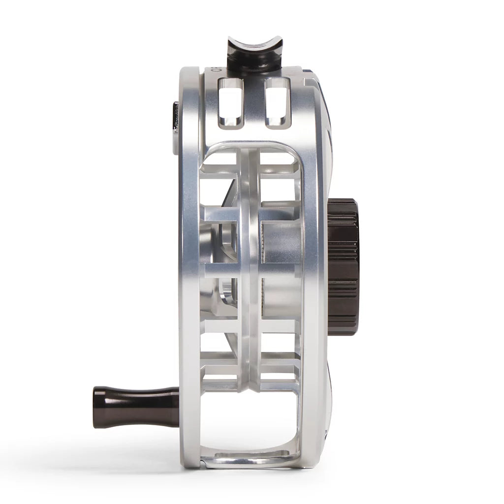 A close-up side profile of an Orvis Hydros metallic silver fly fishing reel with black handle and knob details, set against a clean white background.