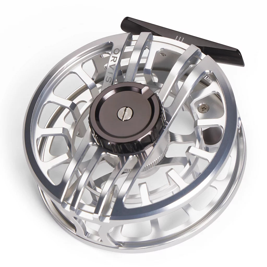 An Orvis Hydros fly fishing reel with a polished silver aluminum body, a dark metallic center knob, and a black handle, shown on a clean white background.