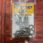 Packaged bead chain eyes for fly tying, available in gold and silver colors, displayed on a fly tying kit card.