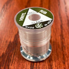 Spool of clear Wapsi UTC Vinyl Rib on a wooden surface