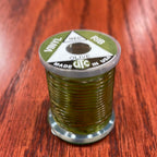 Spool of green Wapsi UTC Vinyl Rib with a label on a wooden surface