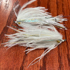Two single stage intruder fishing flies with silver and gold accents, tied for steelhead fishing.