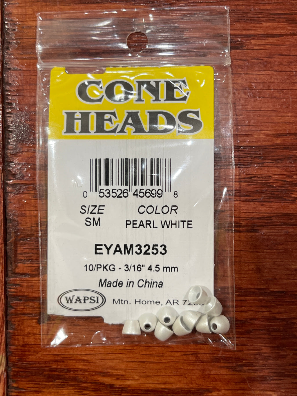 Packaged cone heads with a label on a wooden surface