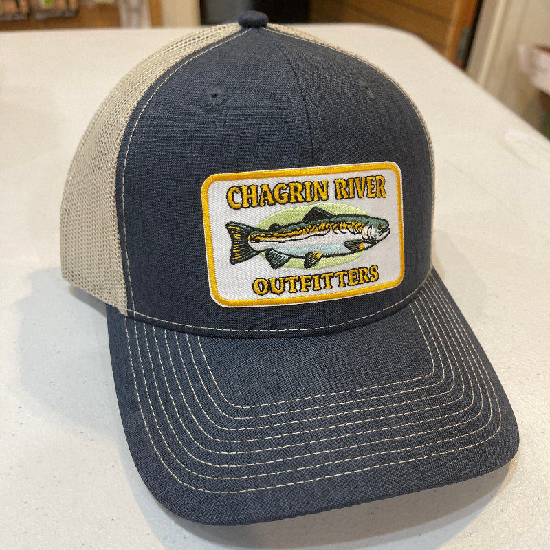 Blue and gray cap with a logo on a white surface