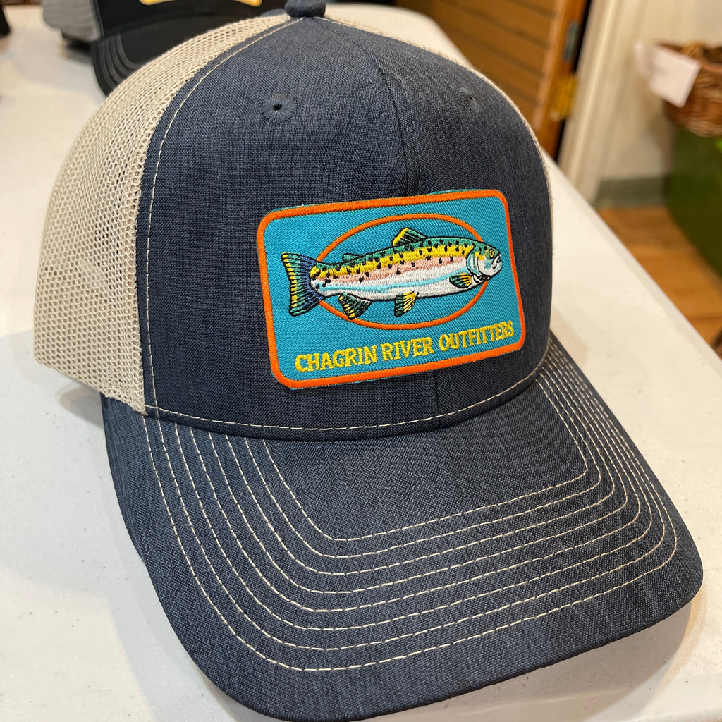 Blue cap with Chagrin River Outfitters logo in an indoor setting