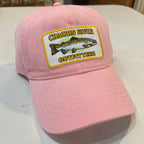 Pink cap with a logo on a white surface
