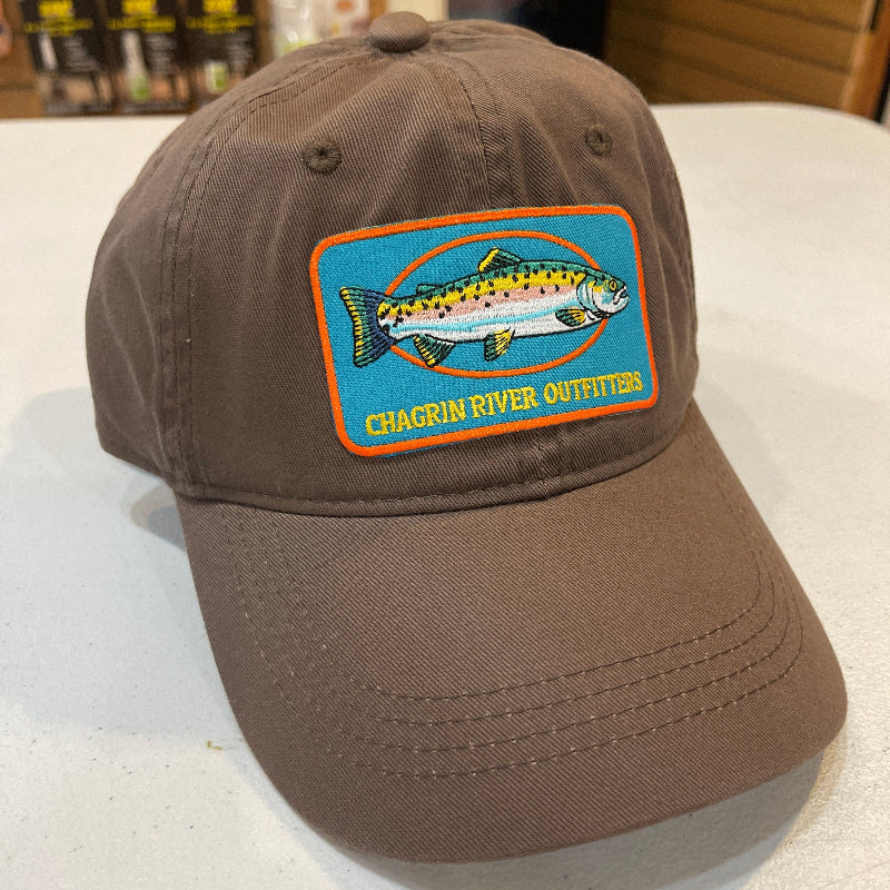 Brown cap with a fish logo patch on a white surface