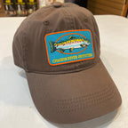 Brown cap with a fish logo patch on a white surface