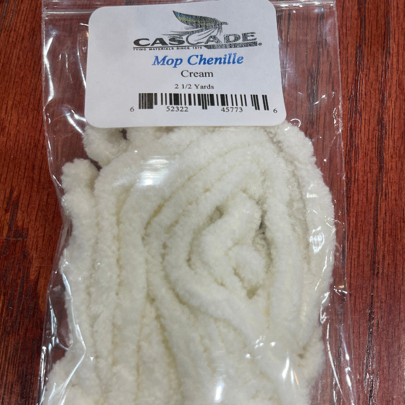 Packaged white yarn with a label on a wooden surface