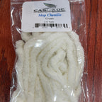Packaged white yarn with a label on a wooden surface
