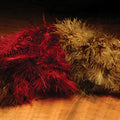 A collection of Hareline Woolly Bugger Marabou feathers in brown and red, arranged on a wooden surface.