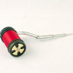A Rite Bobbin Cermag with a black and green handle, a silver metal guide, isolated on a white background.