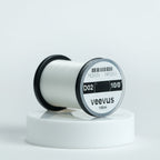 Spool of white veevus fly-tying thread on a white background