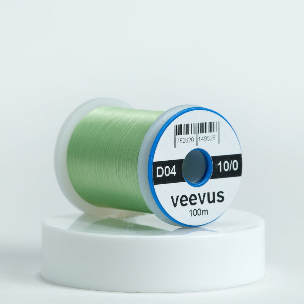 Spool of chartreuse veevus fly-tying thread on a white background