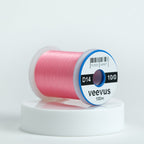 Spool of pink veevus fly-tying thread on a white background